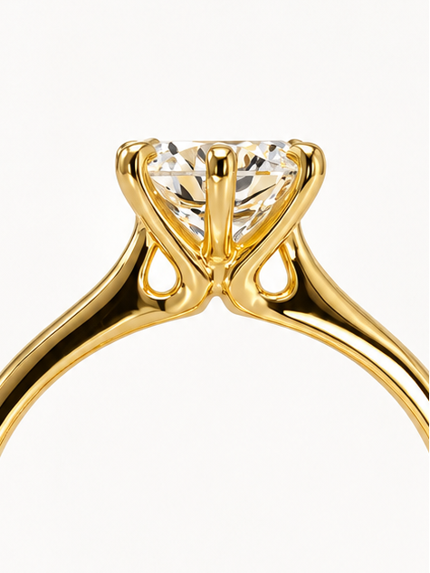 Gold round cut solitaire engagement ring with a diamond.
