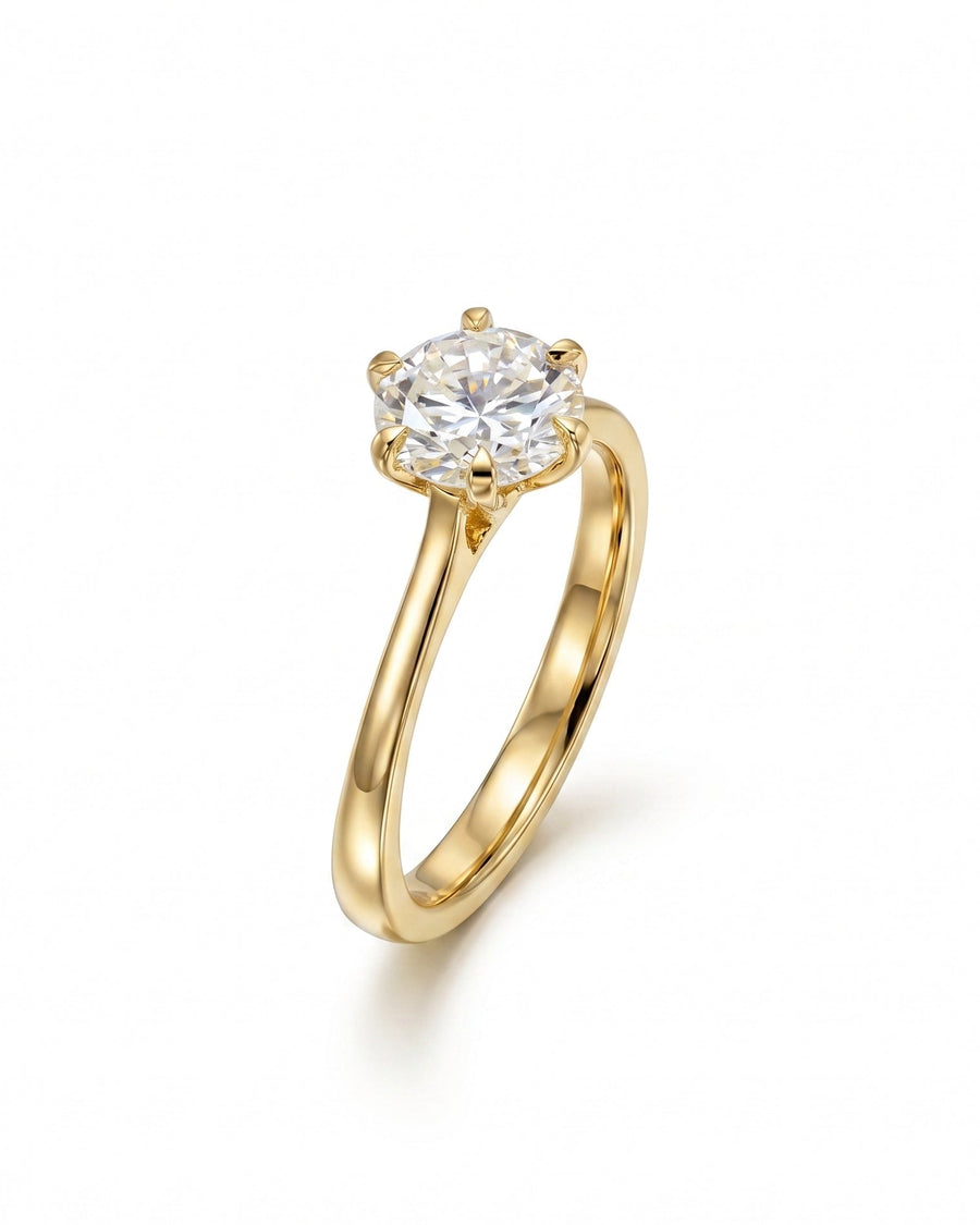 Gold solitaire engagement ring with a round cut diamond.