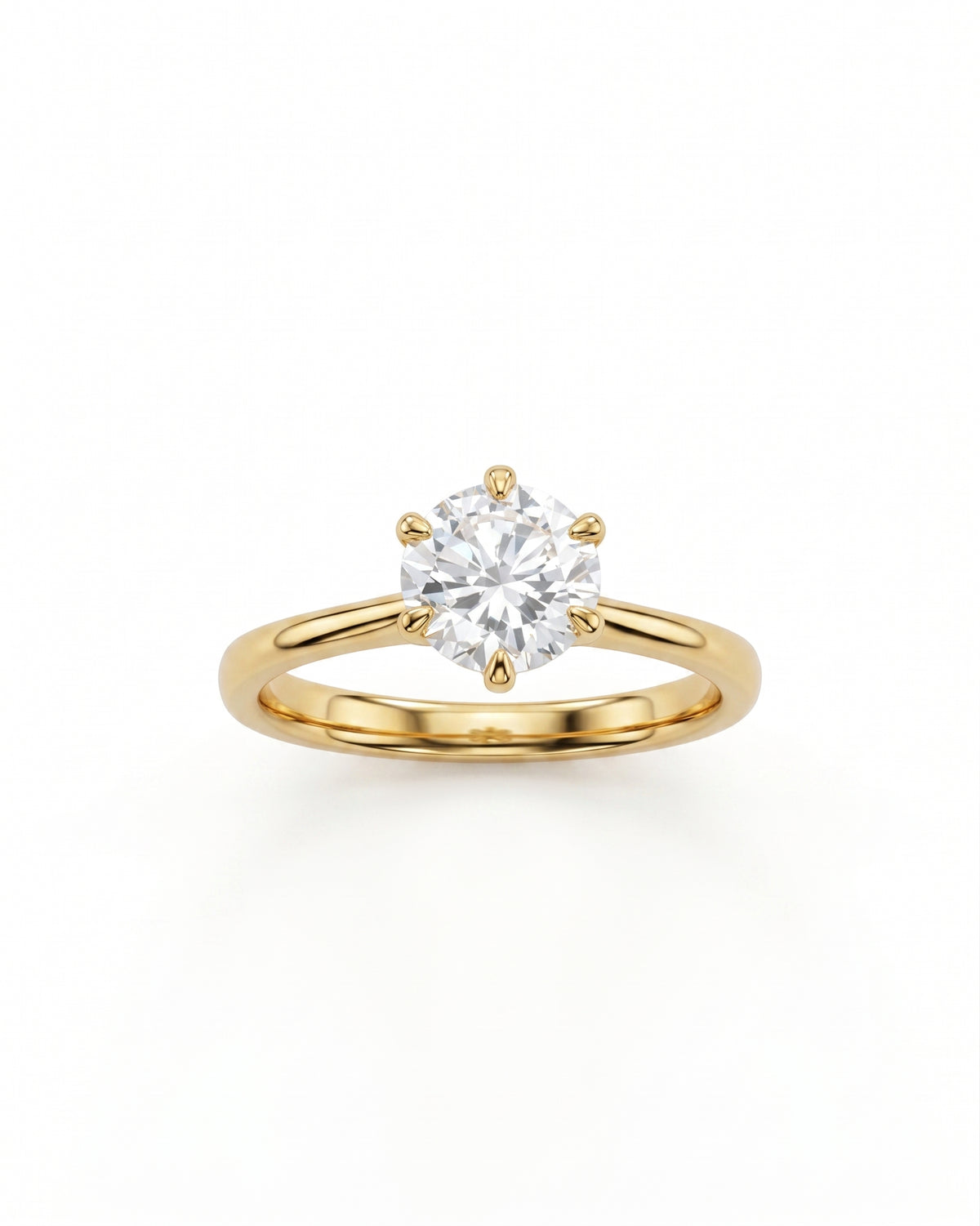 Round cut solitaire diamond engagement ring set in a polished yellow gold band with six prongs.