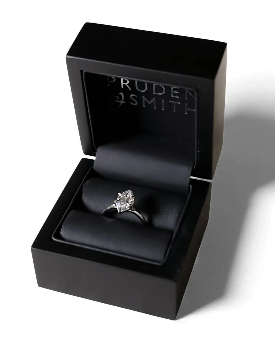 Platinum marquise cut lab-grown diamond tulip engagement ring in a black box.