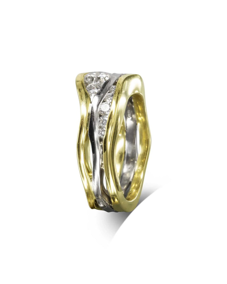Gold and silver three band trap ring with diamond accents.