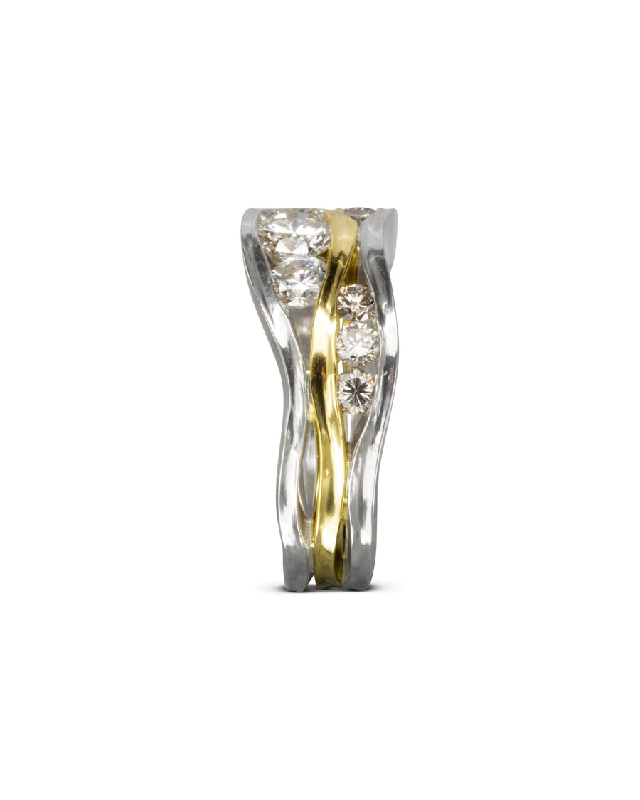 Gold and silver three band trap ring with diamonds.