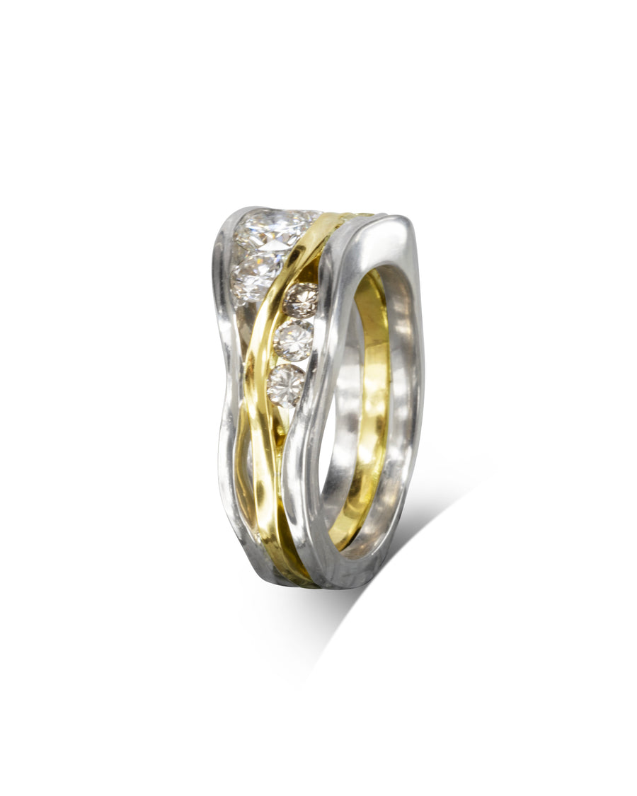 Three band diamond filled trap ring in gold and silver.