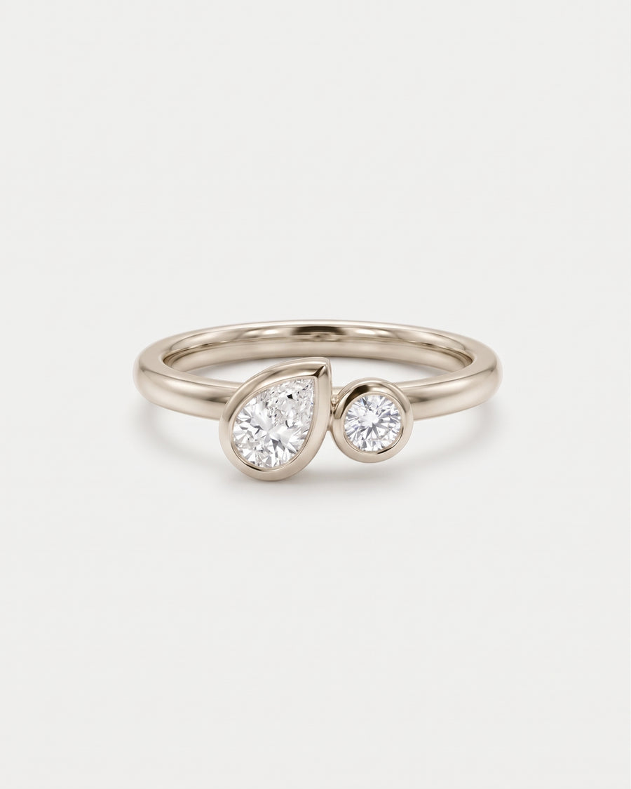 Toi et moi engagement ring in 9ct white gold with bezel-set pear and round lab grown diamonds.