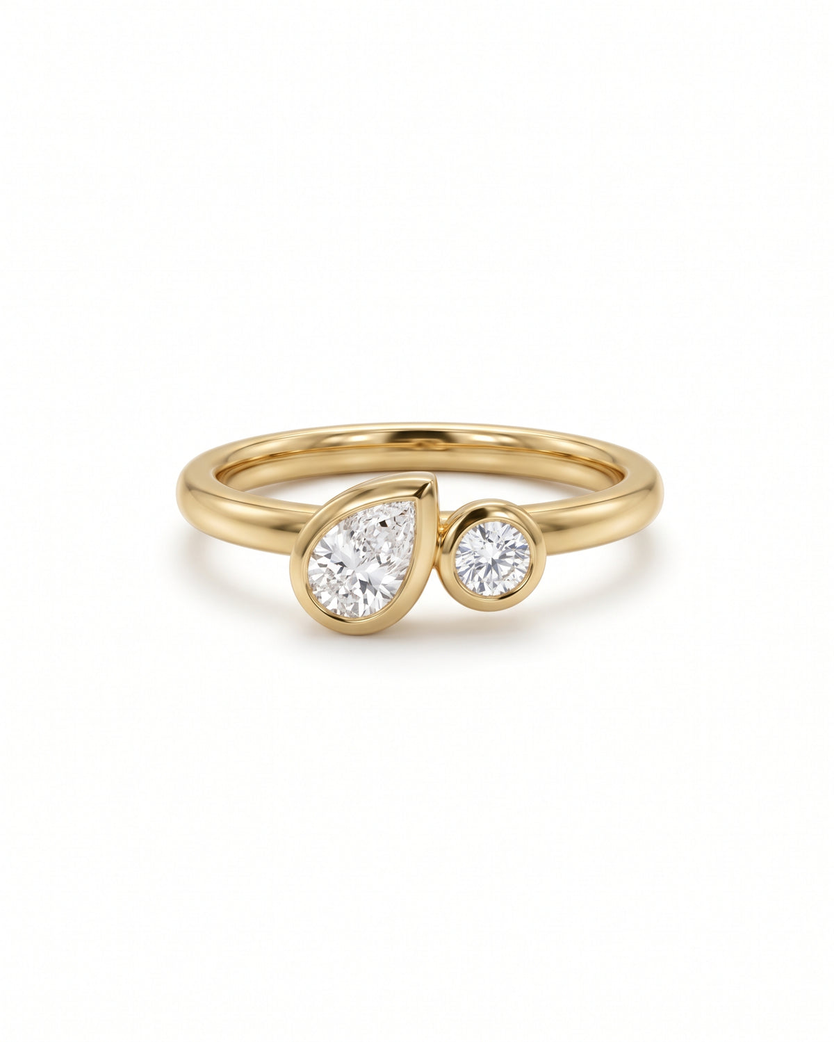 Toi et moi engagement ring in 9ct yellow gold with a bezel-set pear and round lab grown diamond.