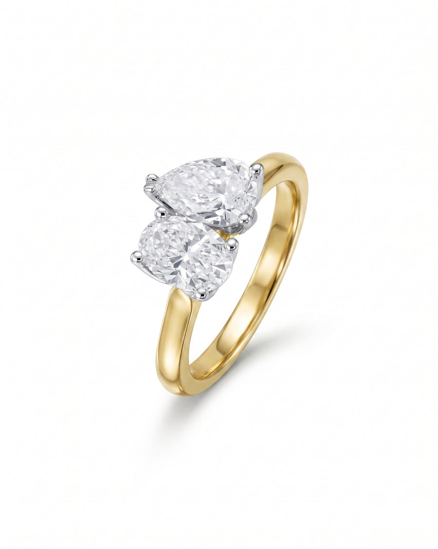 Gold Toi et Moi engagement ring with two pear-shaped claw-set diamonds.