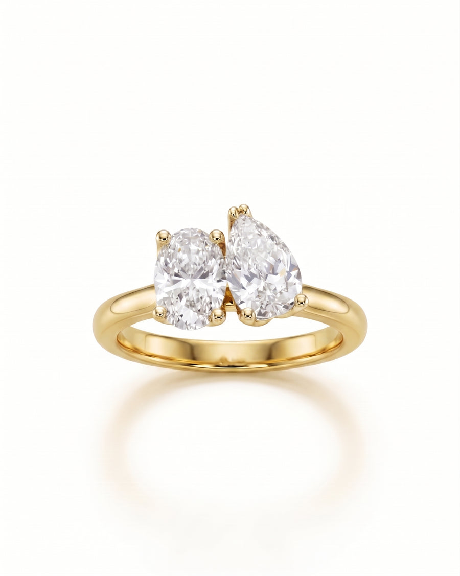 18ct yellow gold engagement ring with oval and pear-shaped laboratory grown diamonds.
