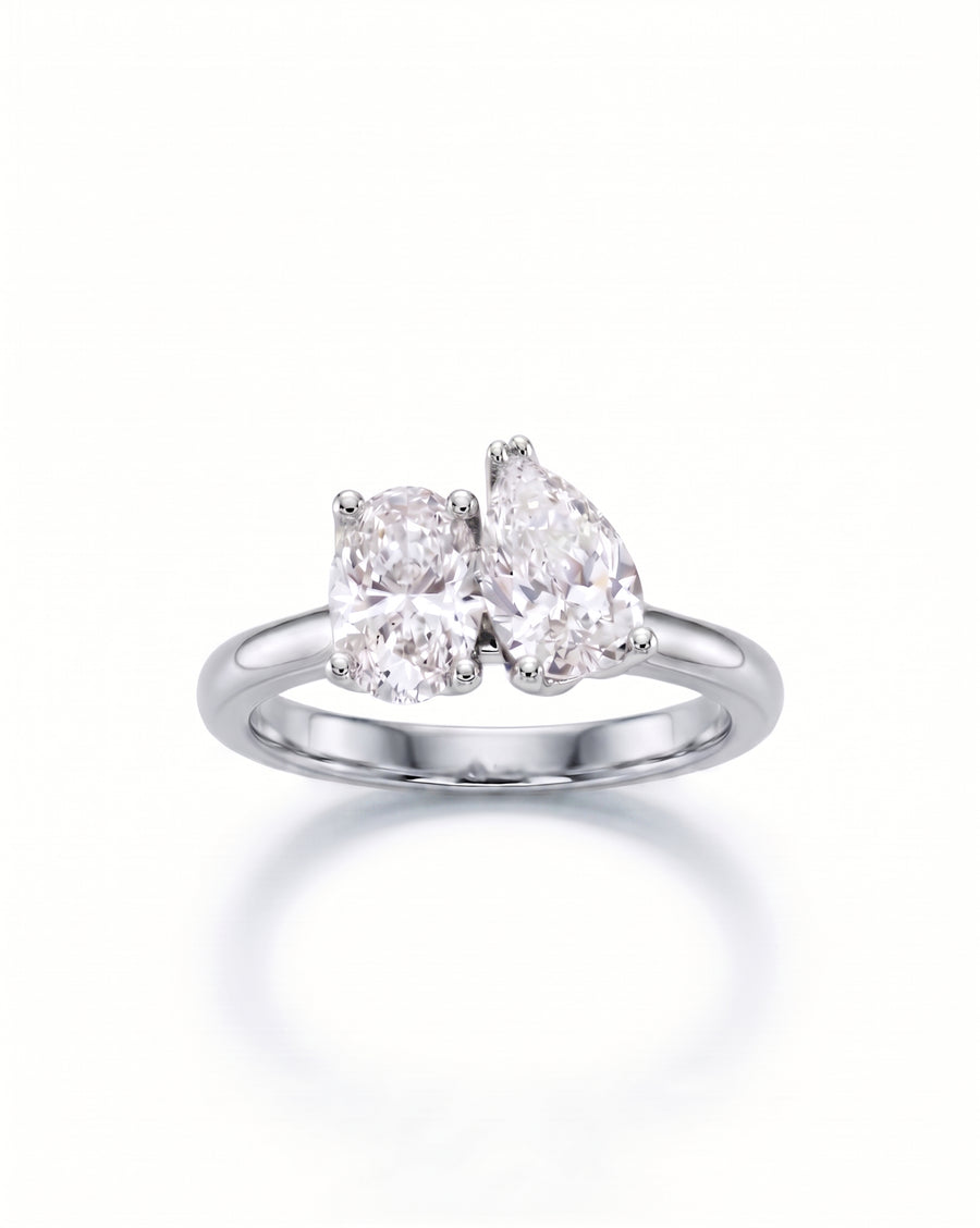 Platinum Toi et Moi engagement ring with a pear and an oval diamond.