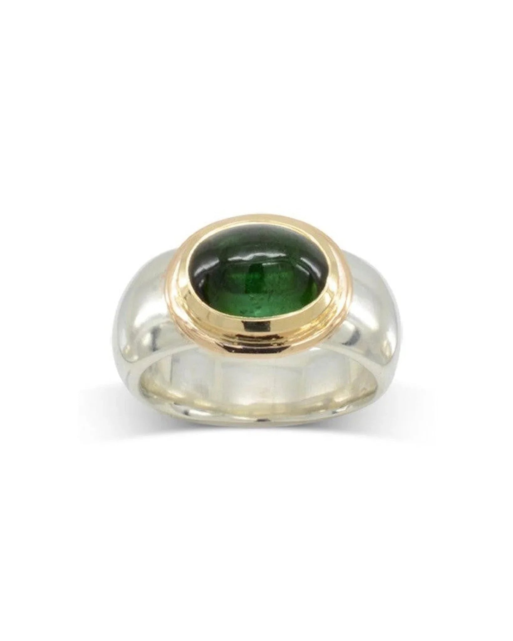 Green tourmaline cabochon ring in a yellow gold bezel setting on a wide silver band.