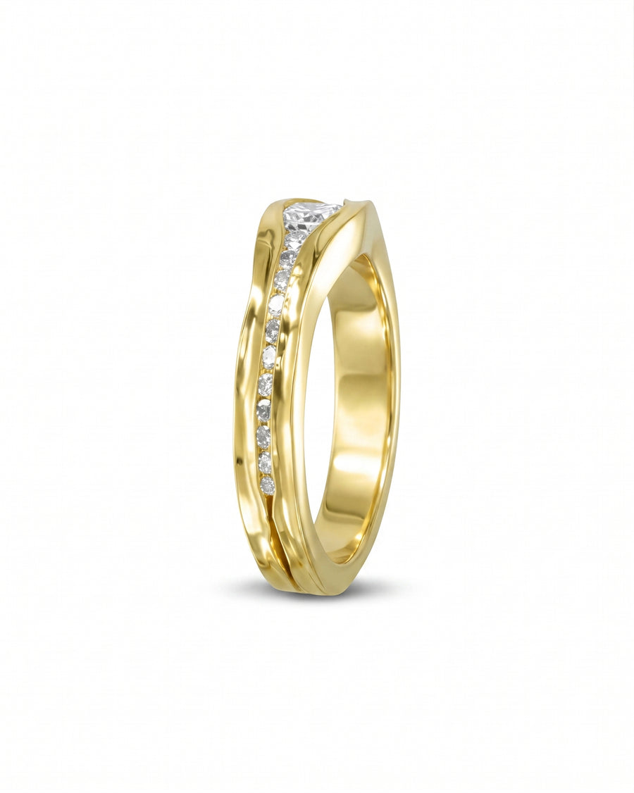 Gold trap diamond engagement ring with channel-set diamonds.