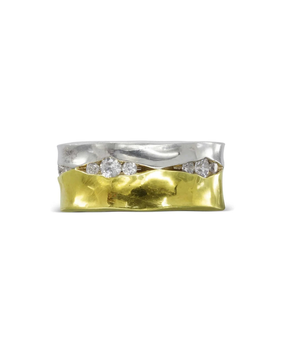 Wide gold and silver eternity ring with trap-set diamonds.
