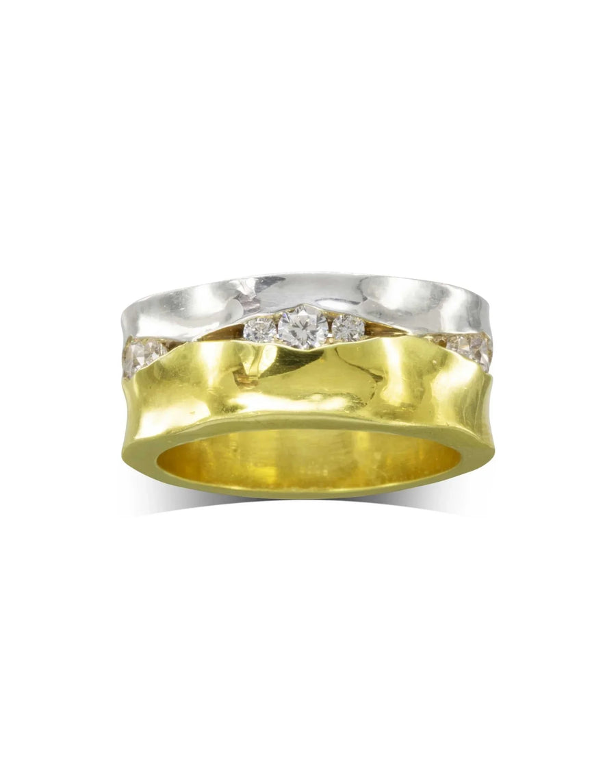 Wide gold and silver eternity ring with trap-set diamonds.