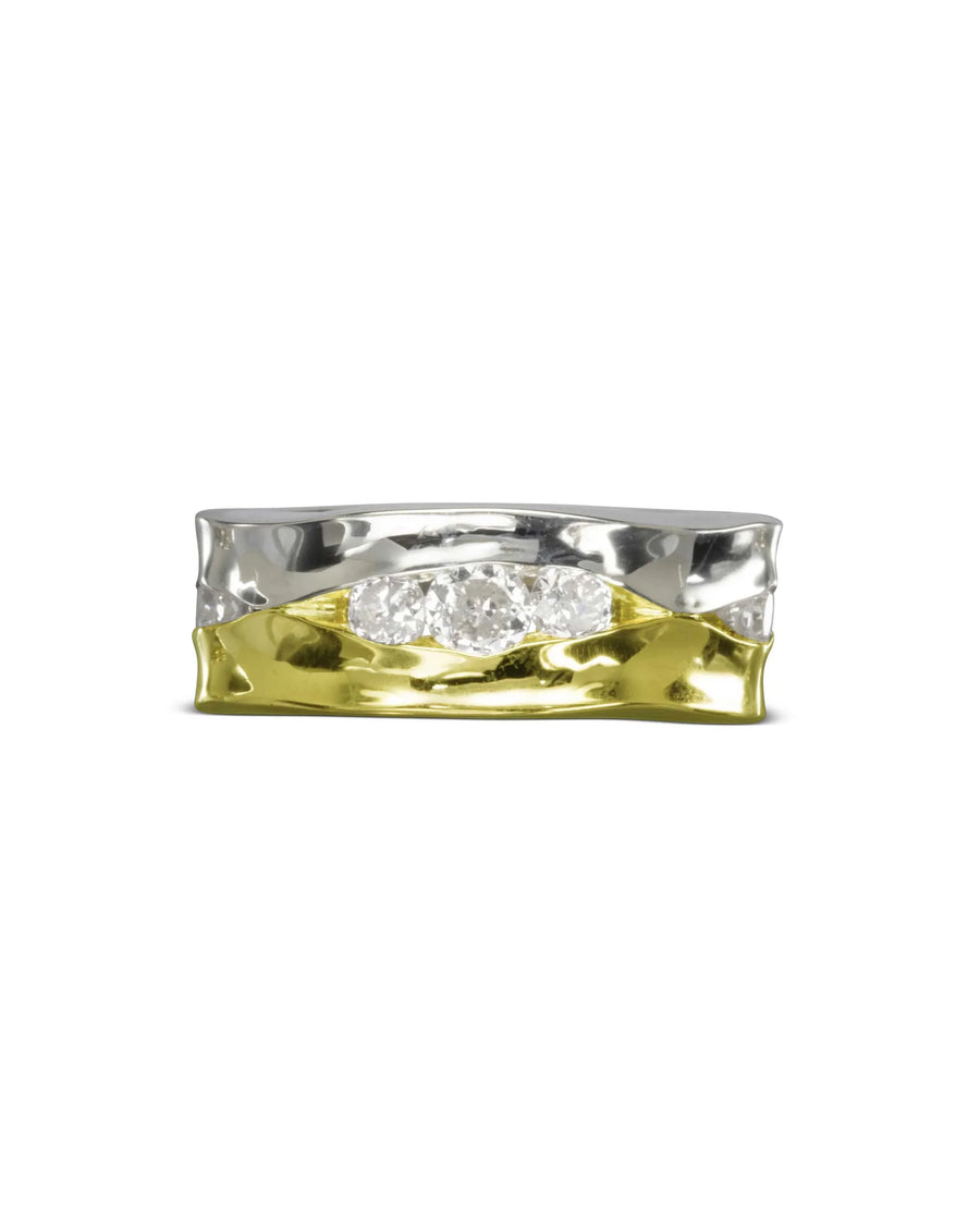 Wide two-tone eternity ring with three round diamonds.