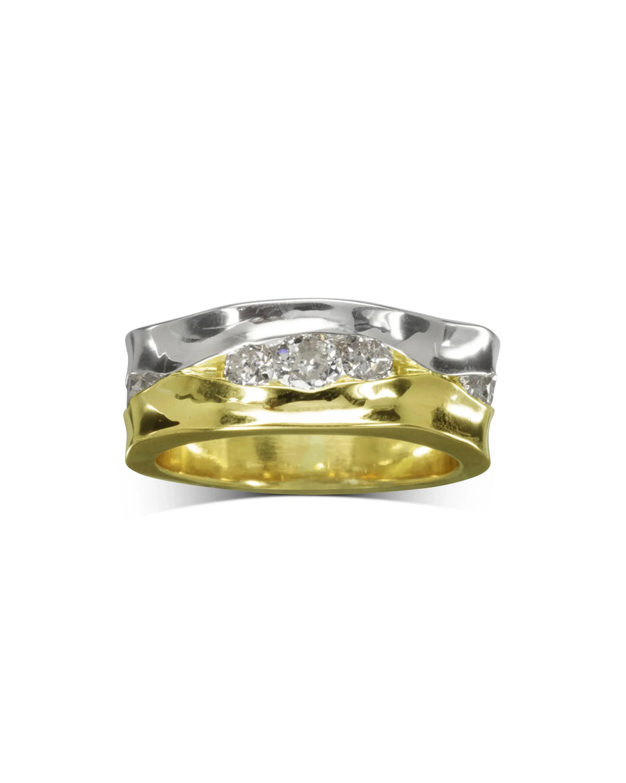 Wide two-tone gold eternity ring with trap-cut diamonds.