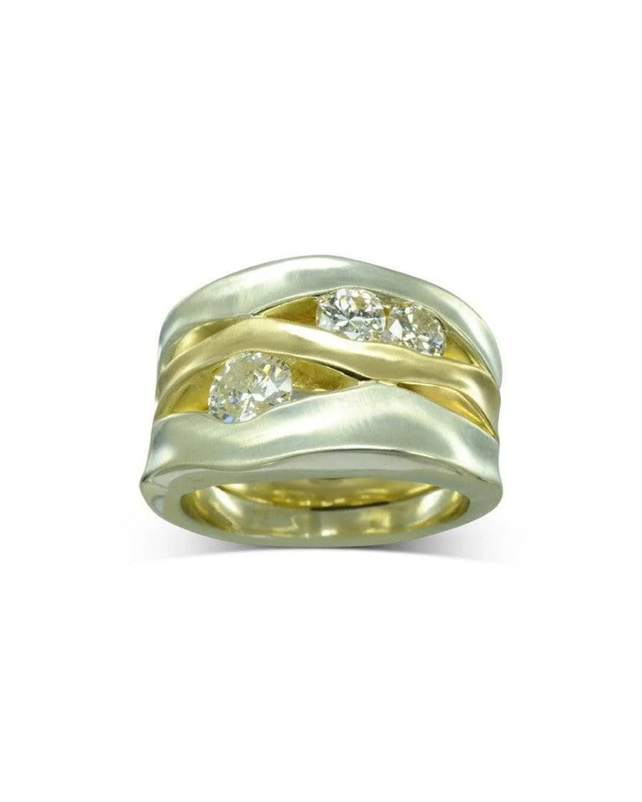 wide mixed metal dress ring with organic curves and three sparkling diamonds set in gold