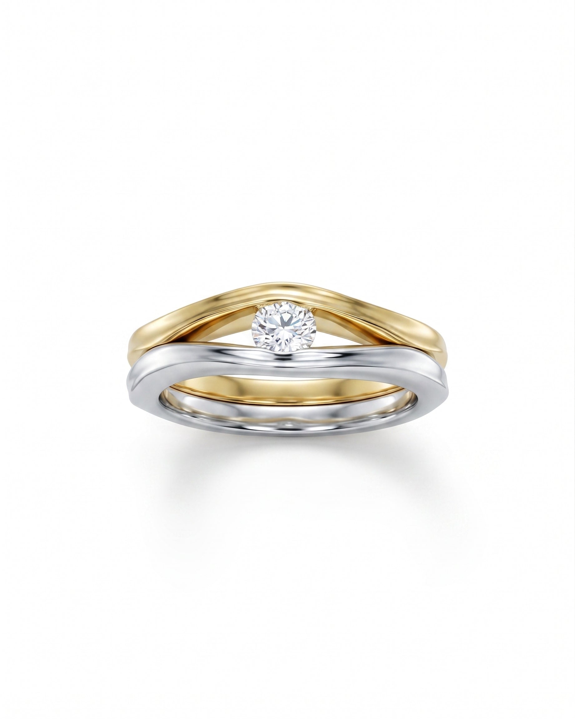 Two-tone gold and silver solitaire engagement ring with a round diamond.