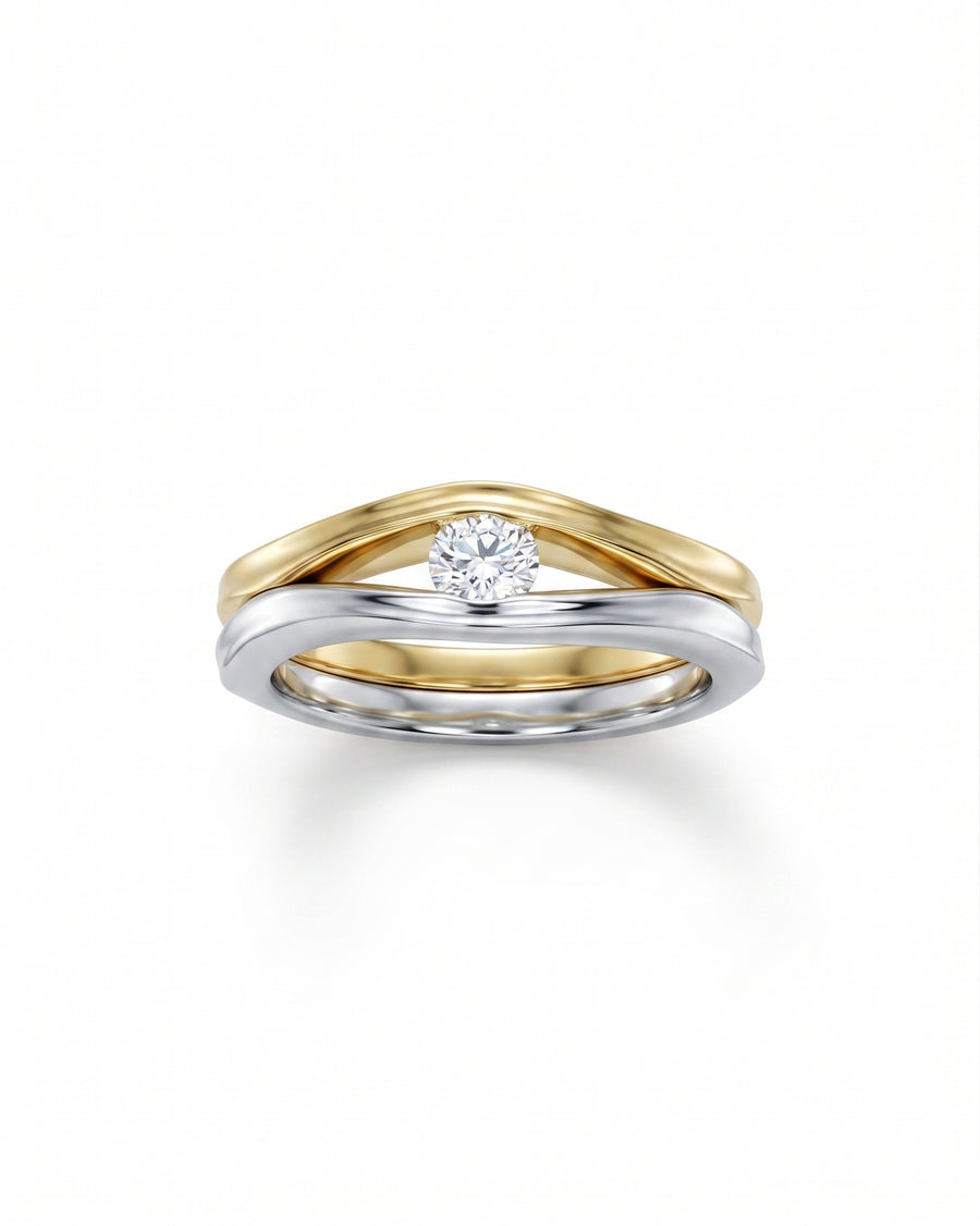 Two-tone gold and silver solitaire engagement ring with a round diamond.