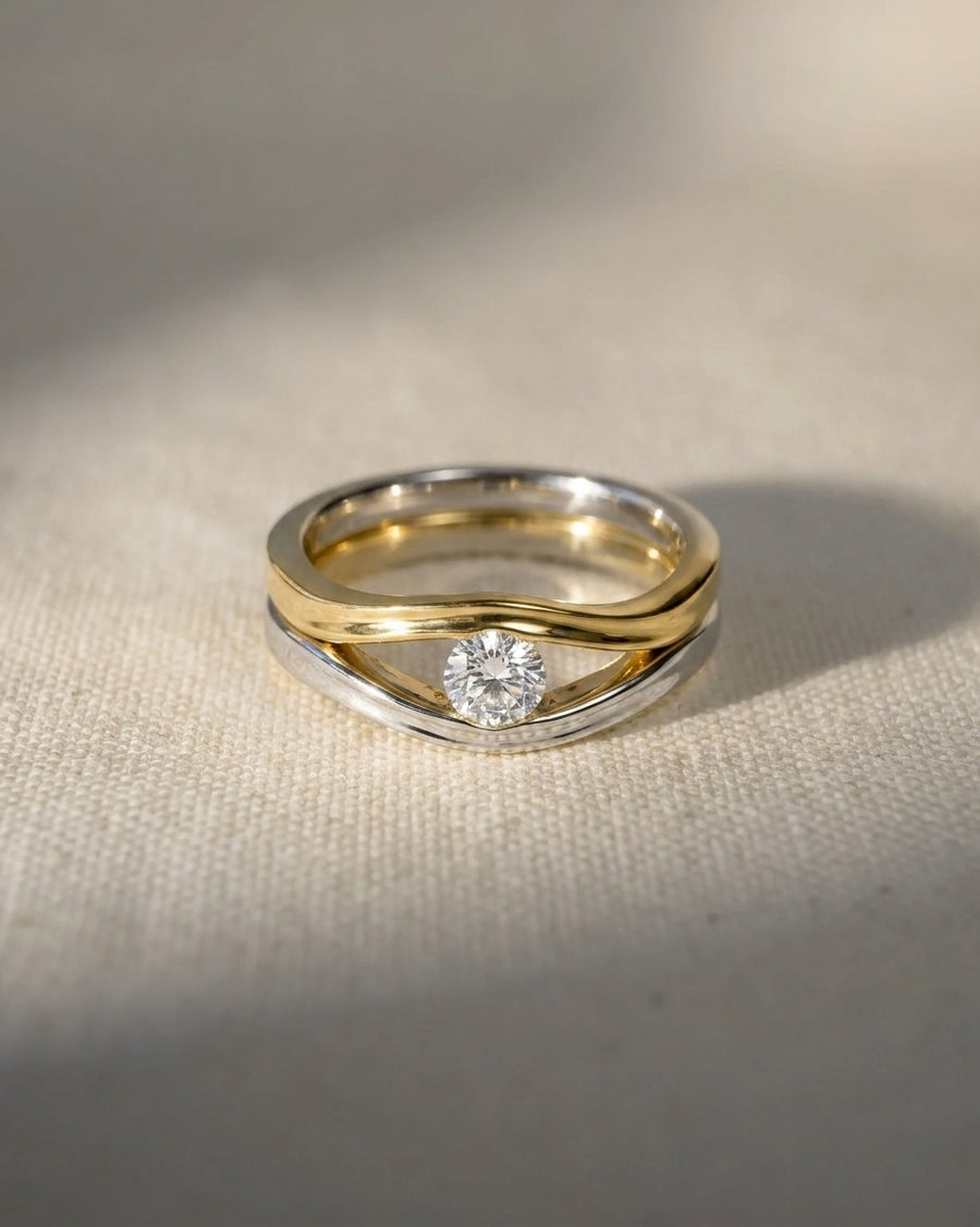 9ct white and yellow gold engagement ring with a round diamond solitaire.