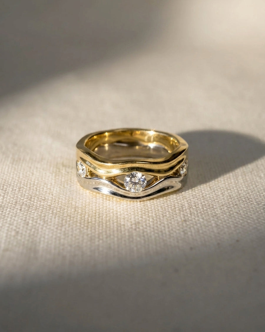 Gold and silver trap four round diamond eternity ring.