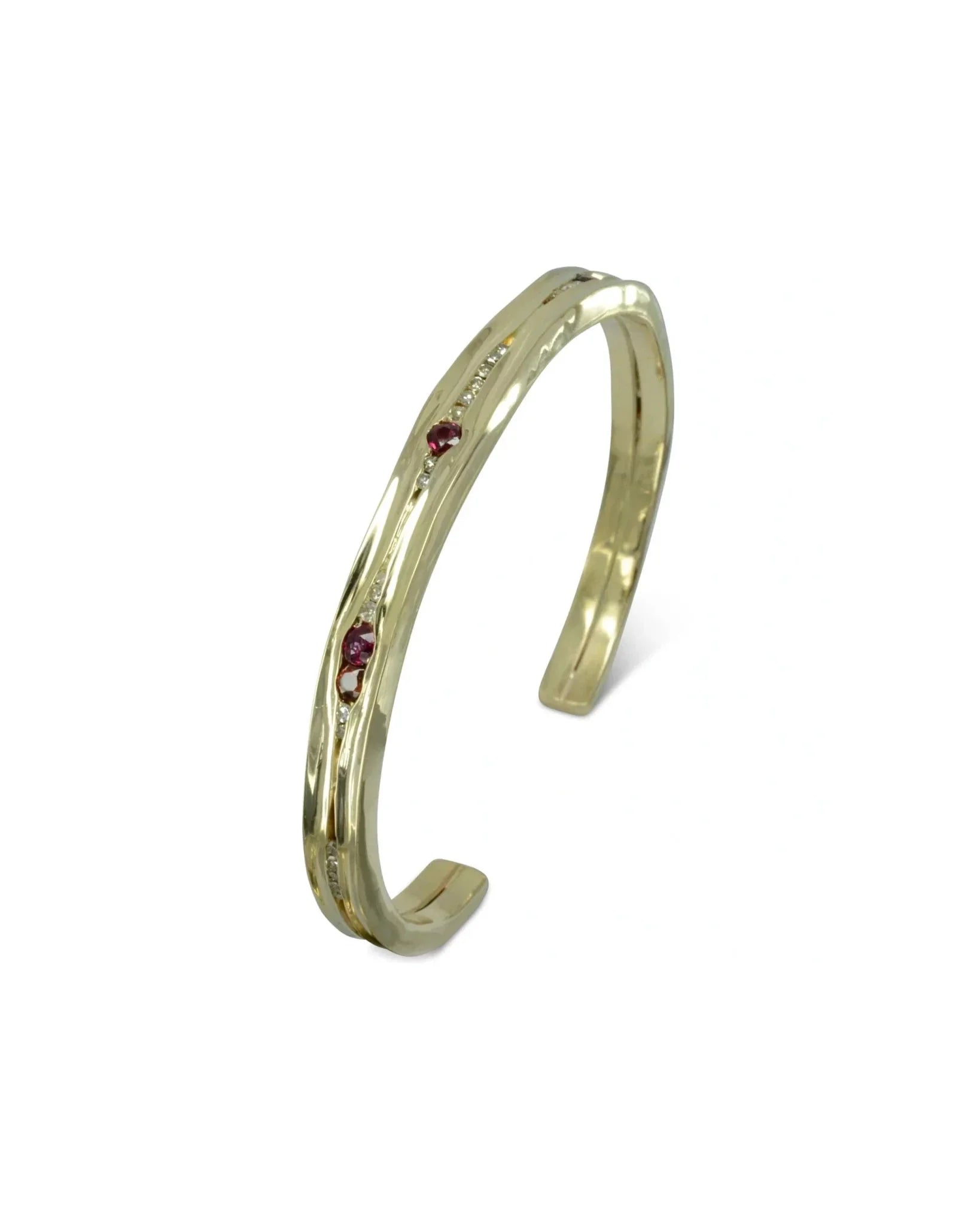 Hammered solid gold bangle with ruby and diamond stones in an organic textured design