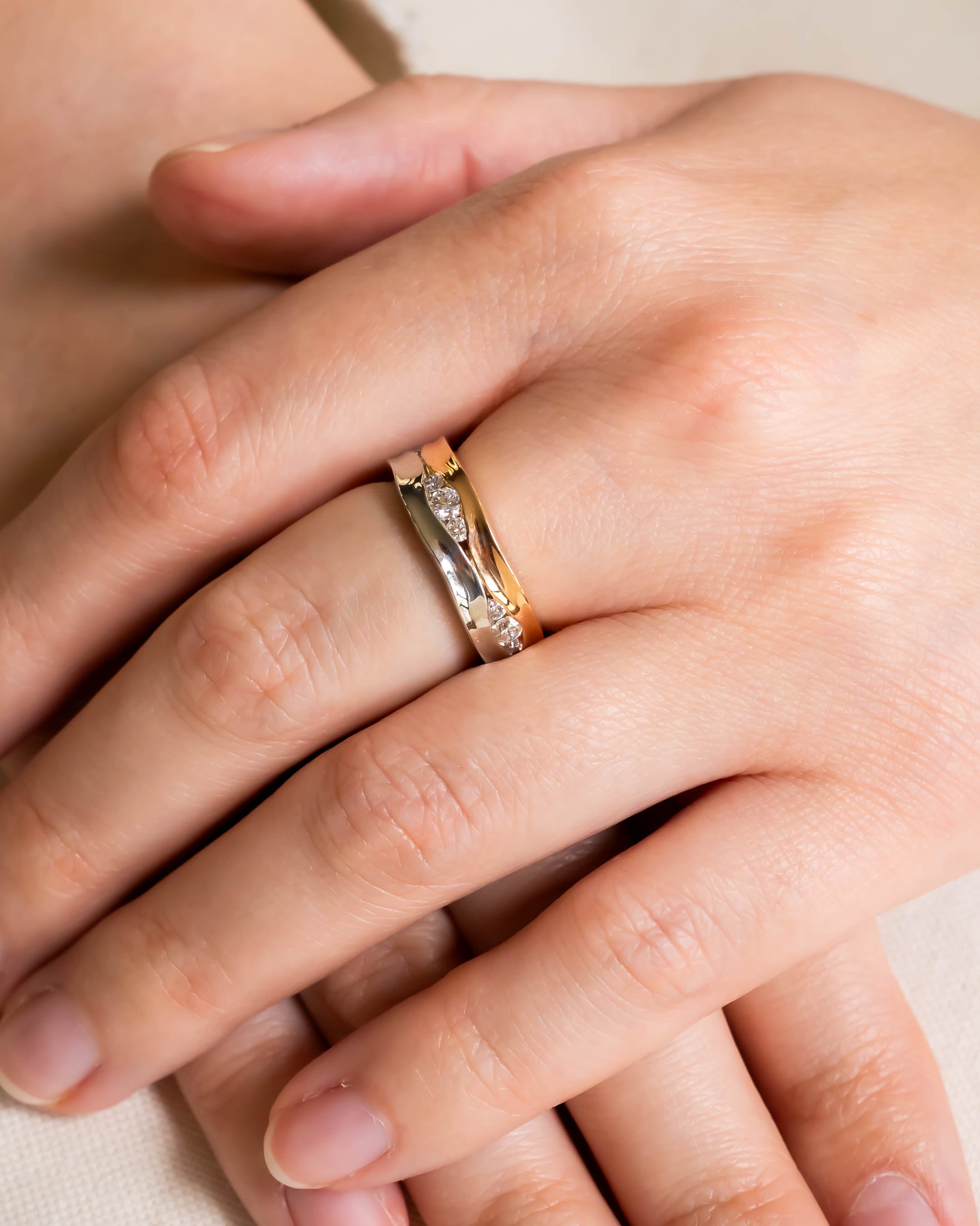 Mixed metal diamond ring with gold and silver bands.
