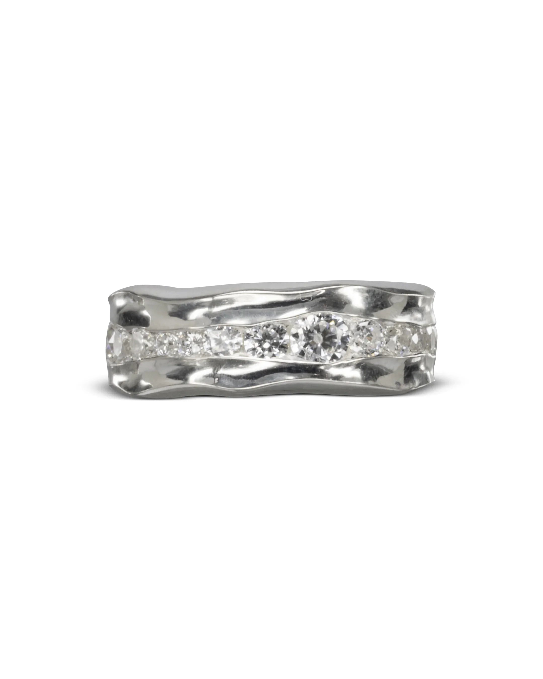Platinum full eternity ring with channel-set diamonds and a wavy design.