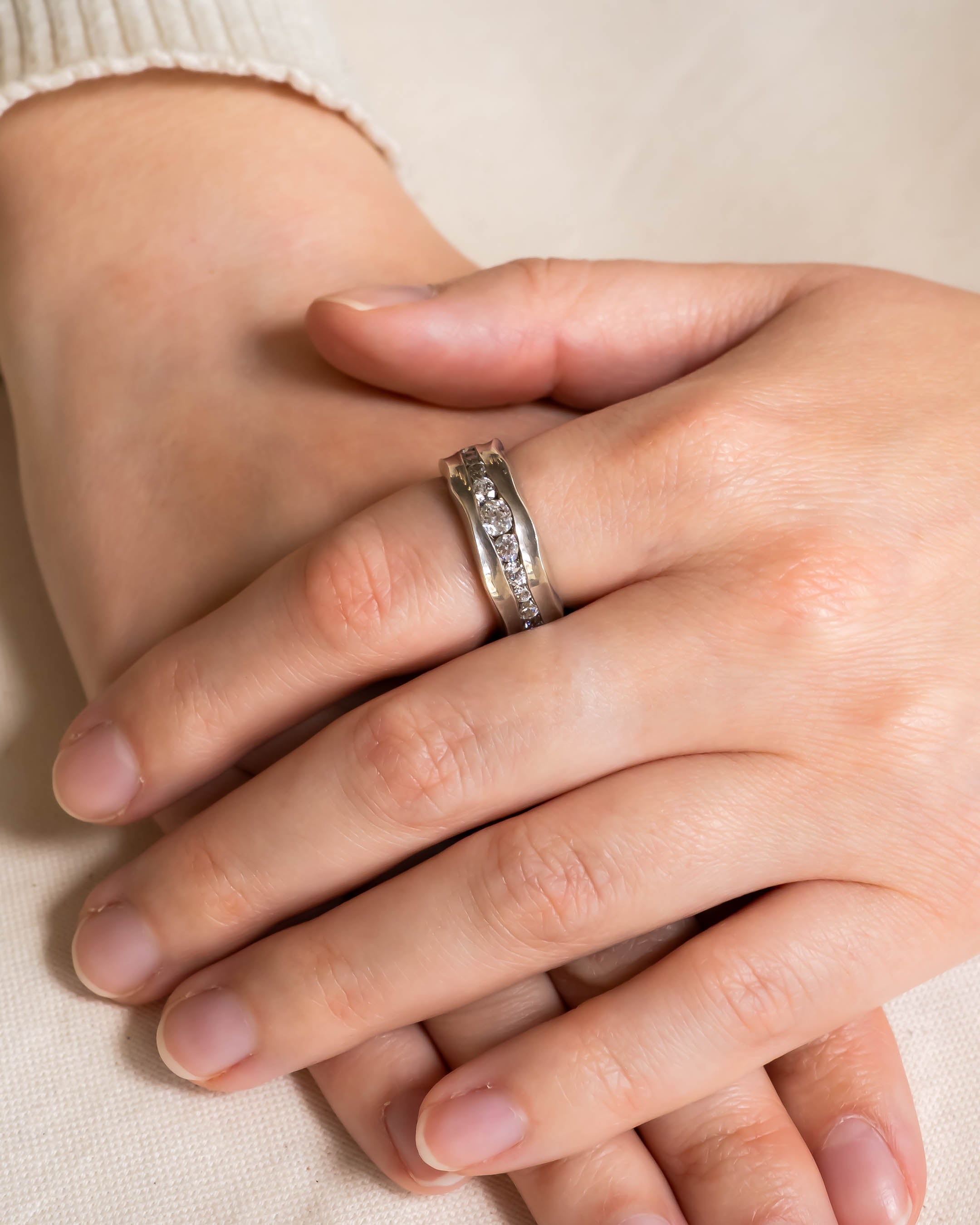 Platinum and diamond full eternity ring on a hand.