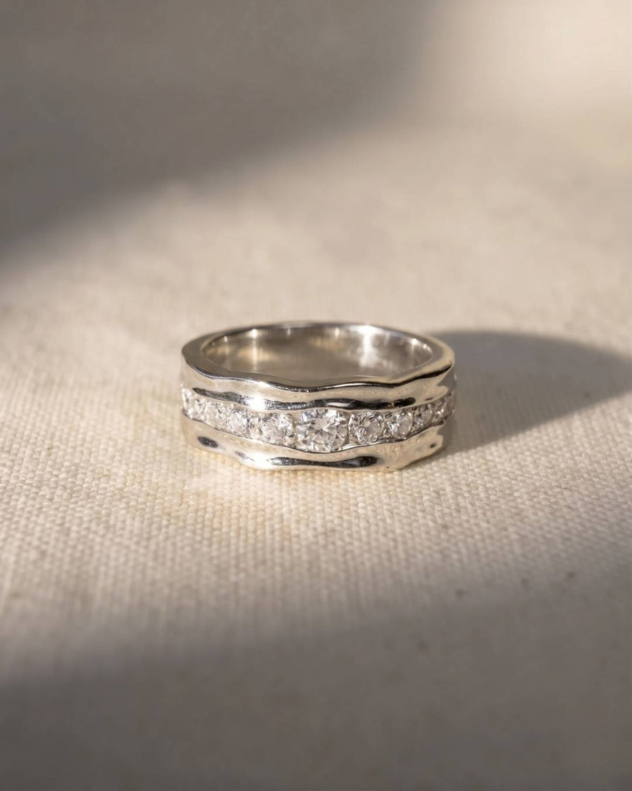 Platinum and diamond full eternity ring with a wavy, textured band.