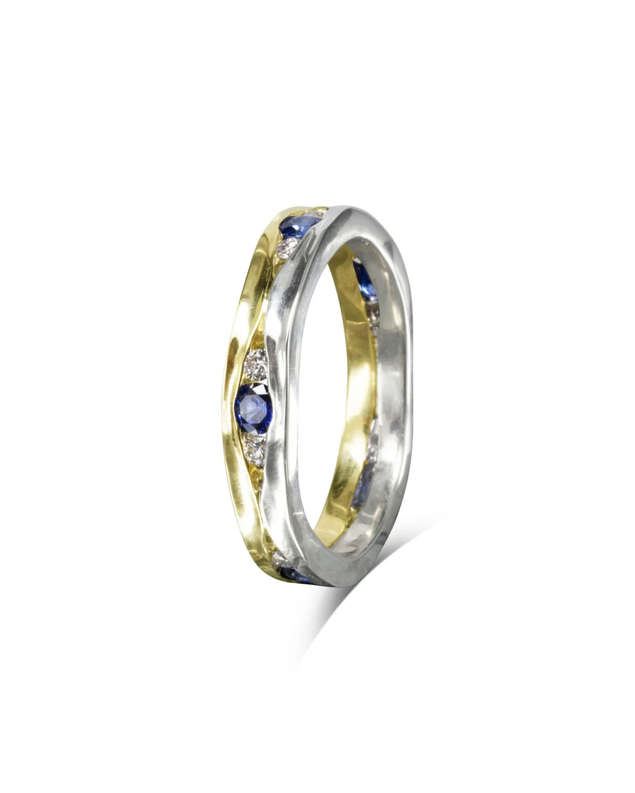 Gold and white gold eternity ring with trap sapphires and diamonds.