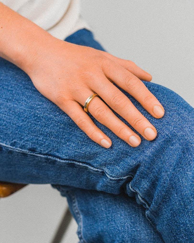 Rose gold diamond eternity ring on hand, casual denim jeans, luxury handmade jewellery