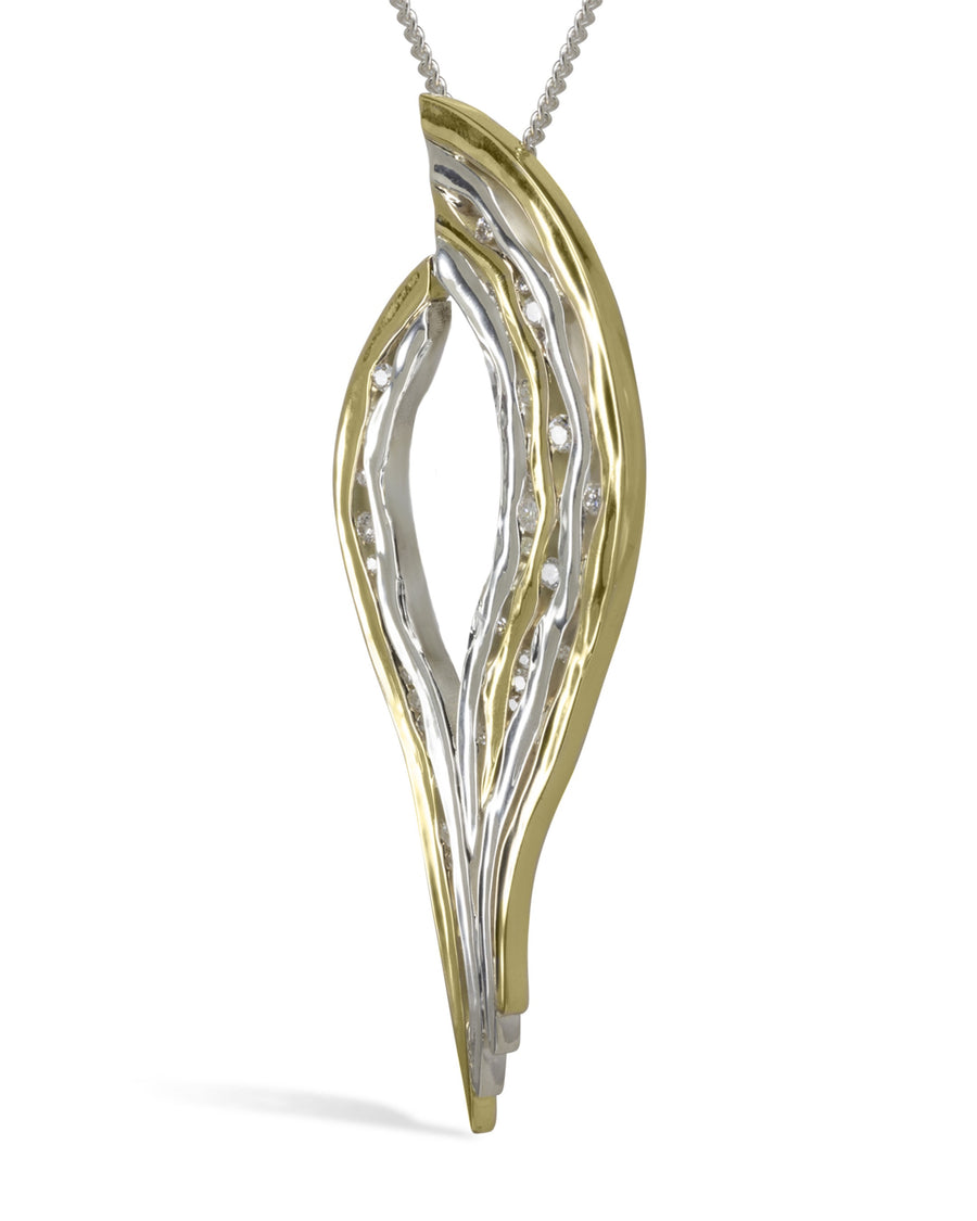 Two-tone gold and silver hammered pendant with small diamonds on a chain.