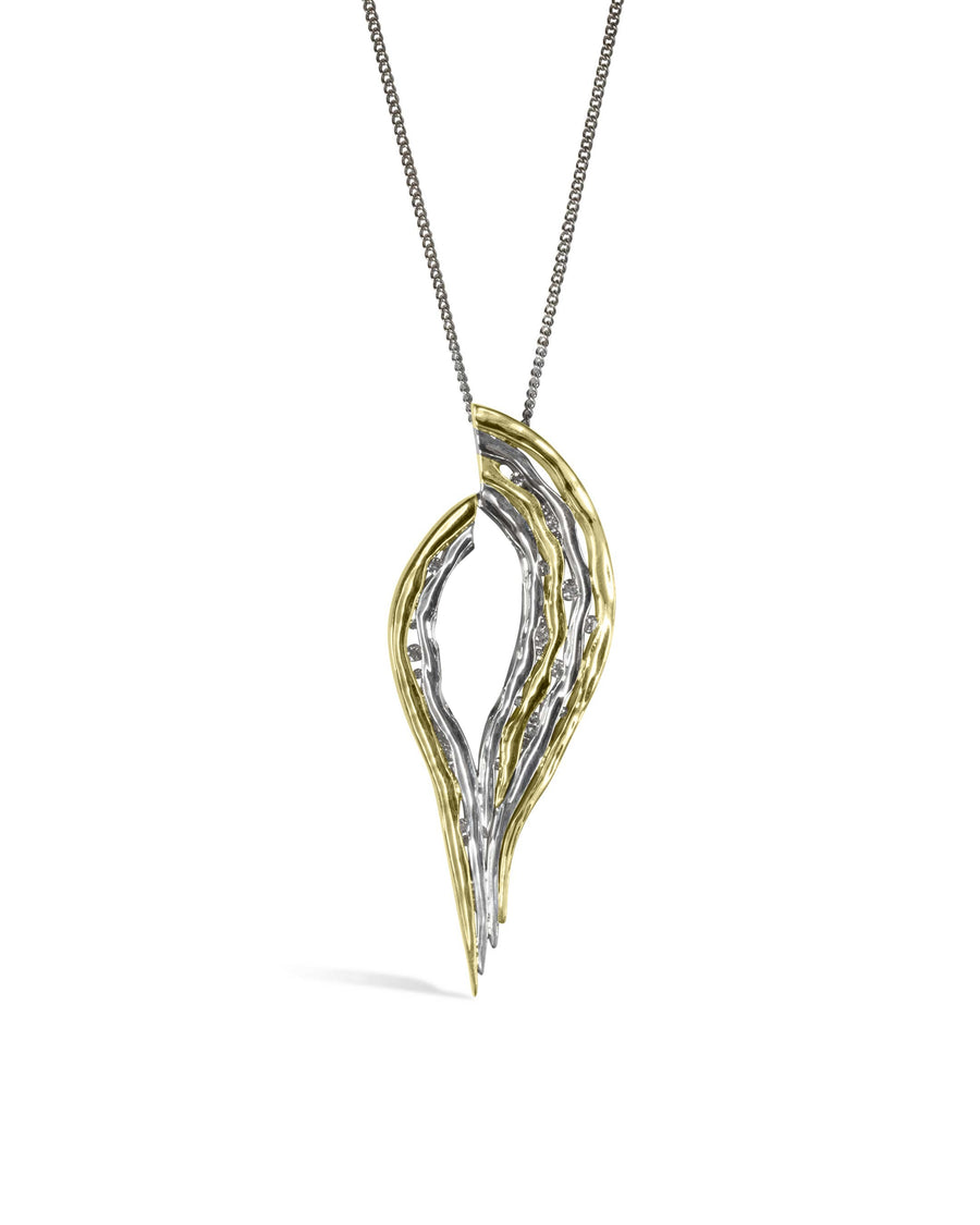 Two-tone gold and silver hammered pendant with small diamonds on a chain.