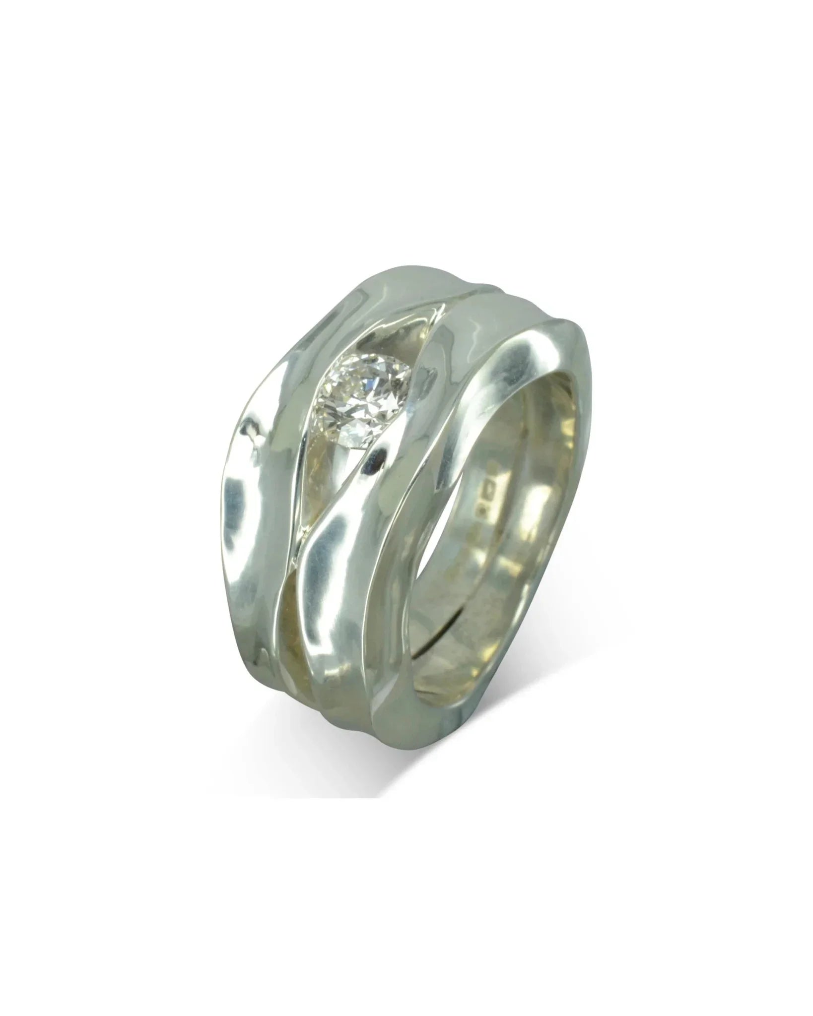 Wide silver dress ring with organic curves and a central sparkling diamond