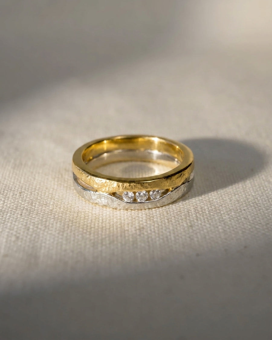 9ct white and yellow gold textured ring with three diamonds.