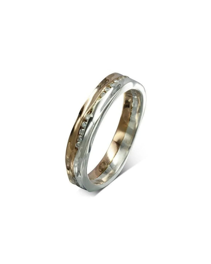 Rose gold and silver eternity ring with a row of round diamonds on a white background