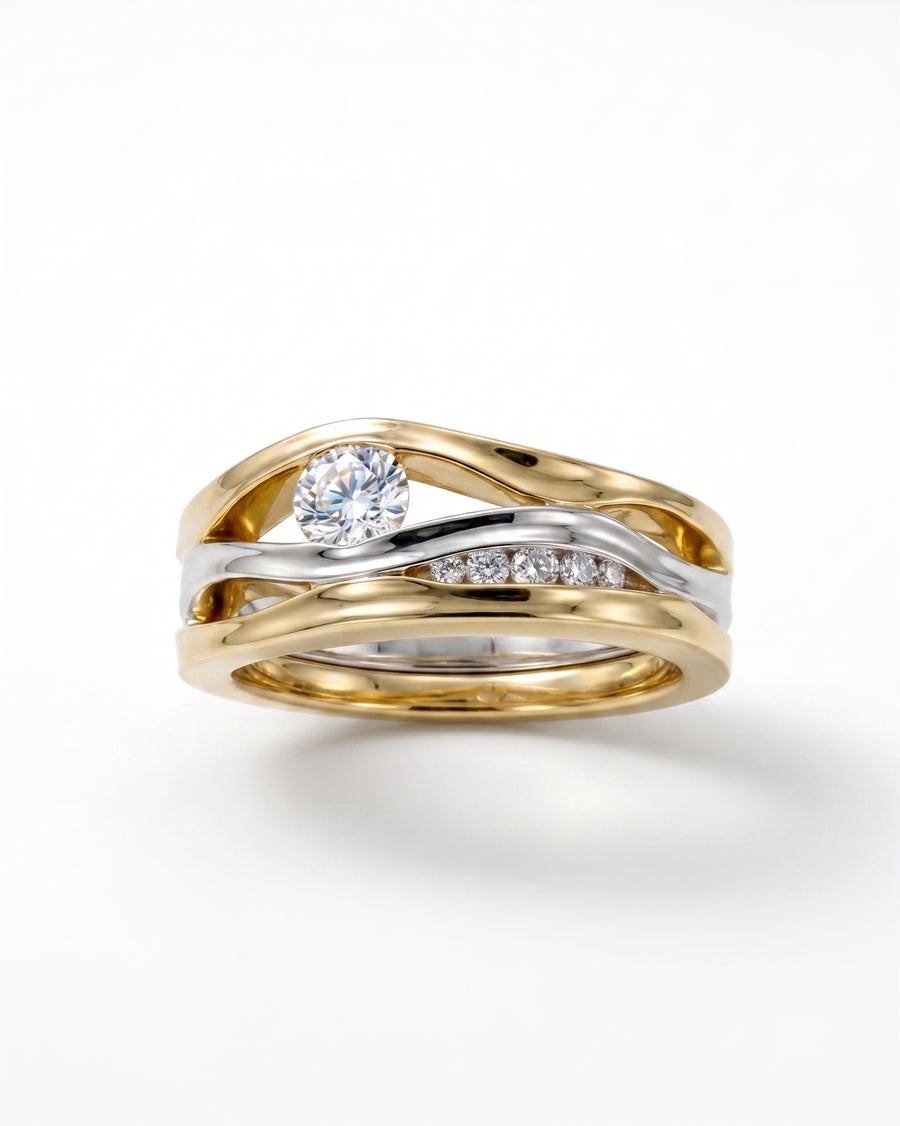 Gold and silver three-band diamond ring with a large center stone and smaller accent diamonds.