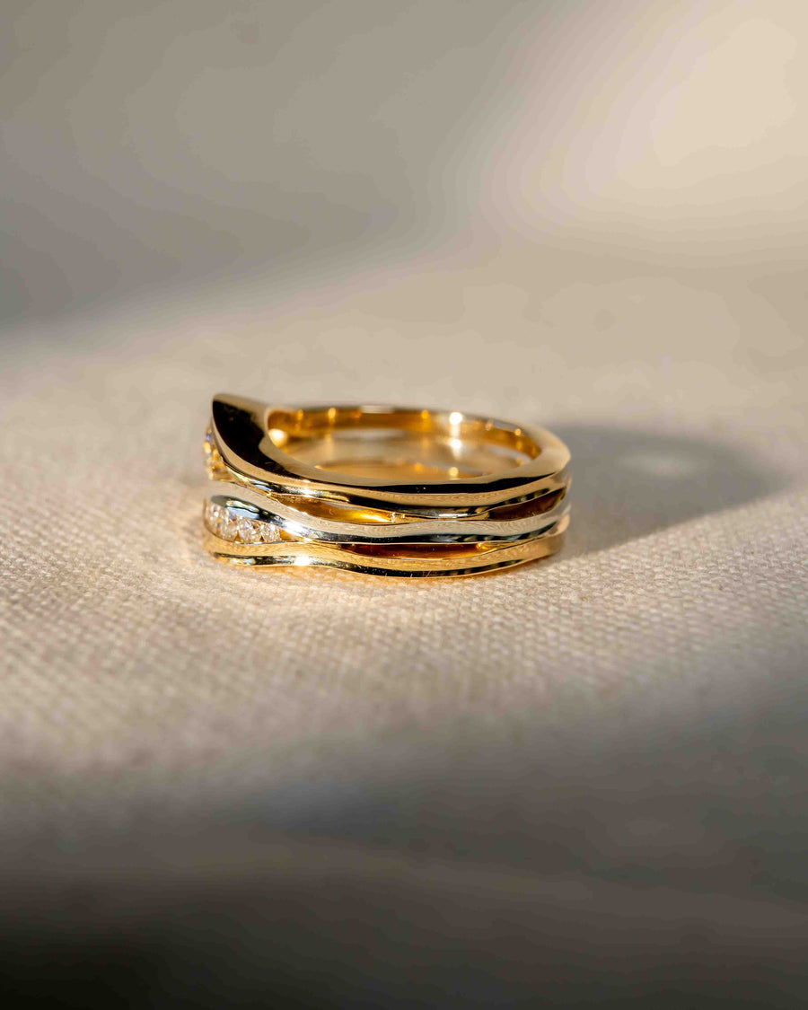 Gold and white gold three-band ring with small diamonds.