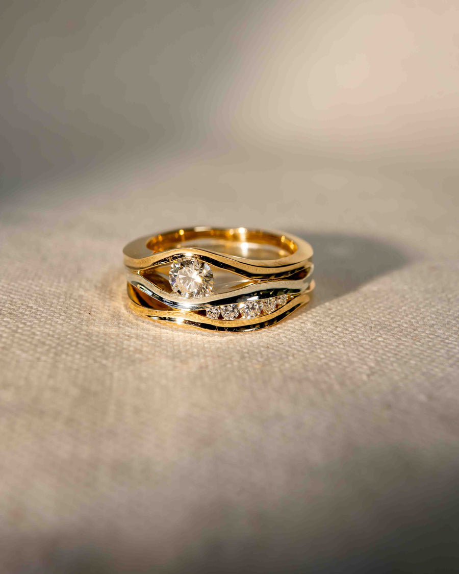 9ct white and yellow gold three band ring with a round diamond and smaller accent diamonds.