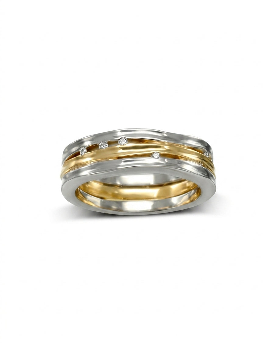 Three-band organic eternity ring in white and yellow gold, set with small round diamonds.