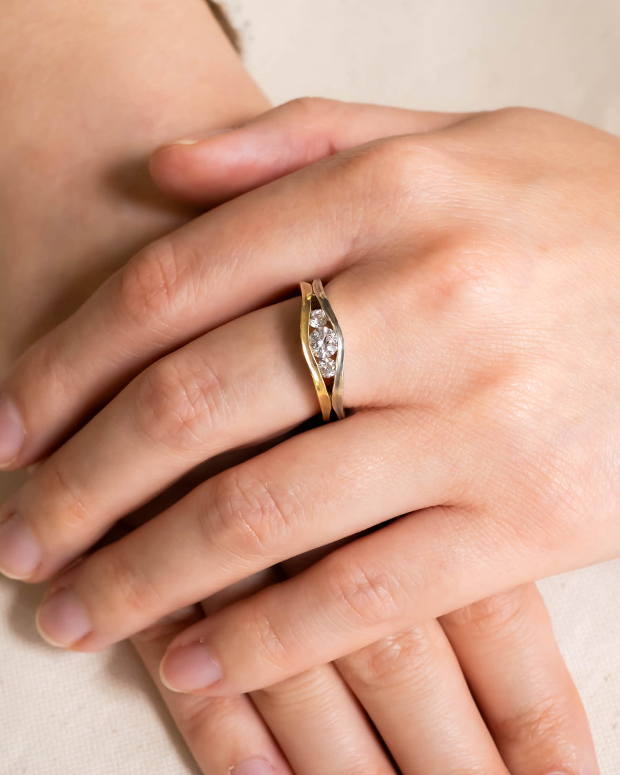Gold and silver unusual engagement ring with three oval diamonds.
