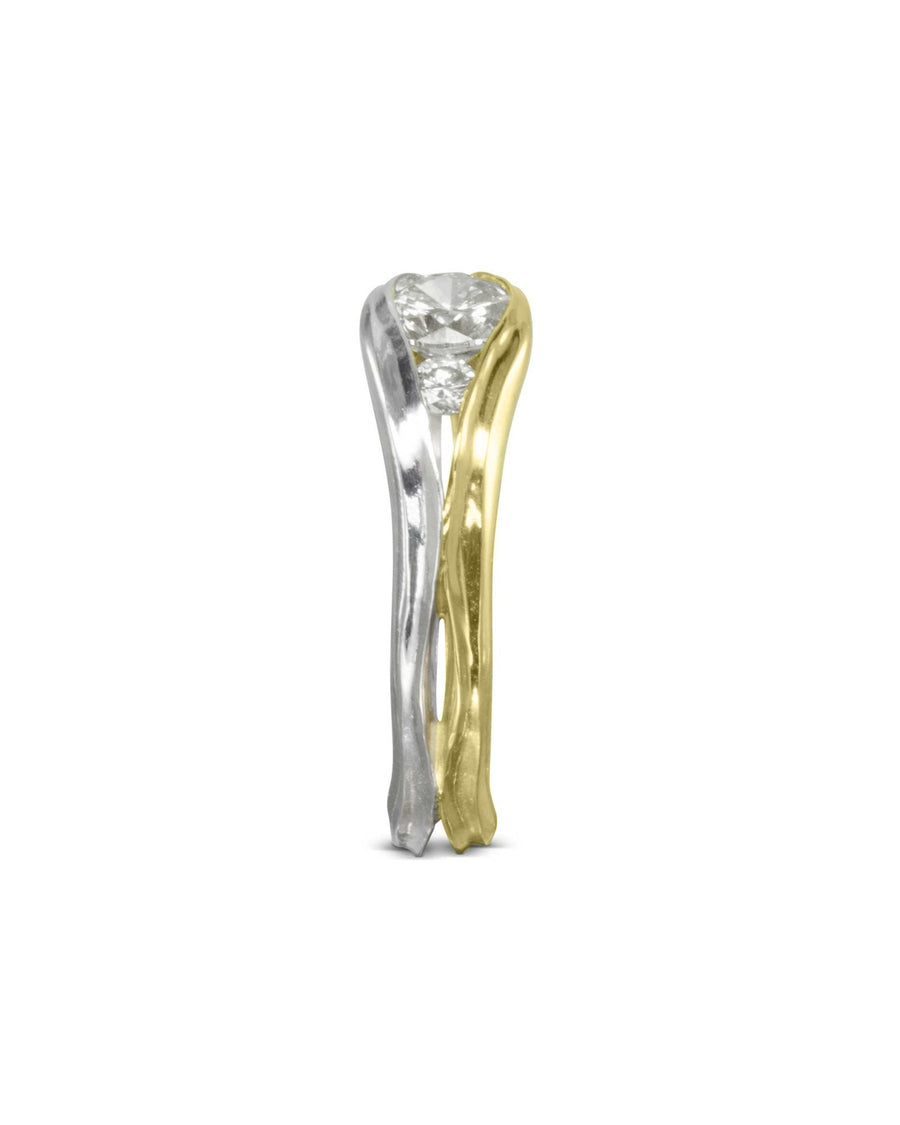 Two-tone gold engagement ring with a round diamond in a unique bypass setting.