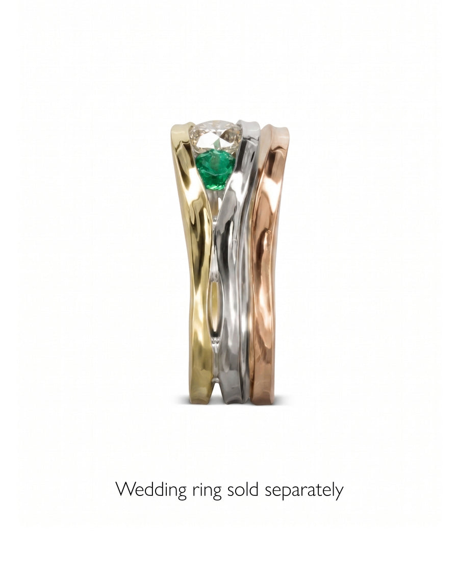 Gold, silver, and rose gold ring with a diamond and emerald.