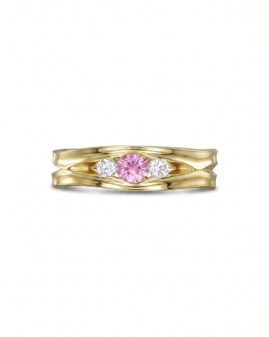 Gold engagement ring with a pink sapphire and two diamonds.
