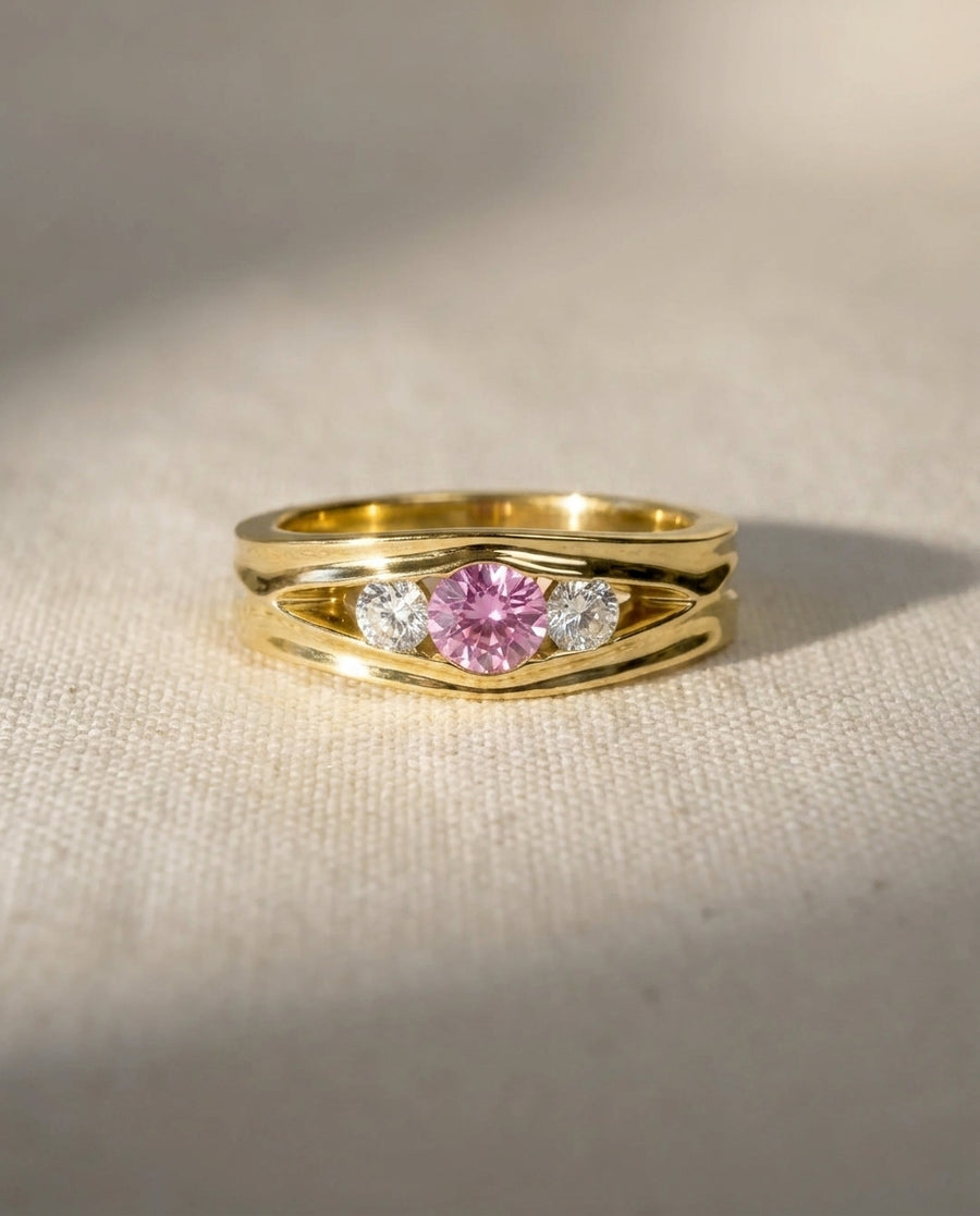 9ct yellow gold ring with a pink sapphire and two diamonds.