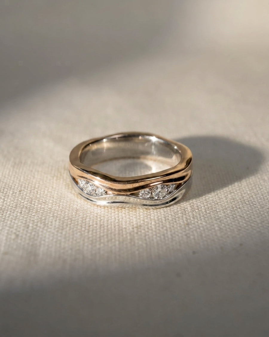 9ct white and rose gold eternity ring with diamonds in a wavy design.