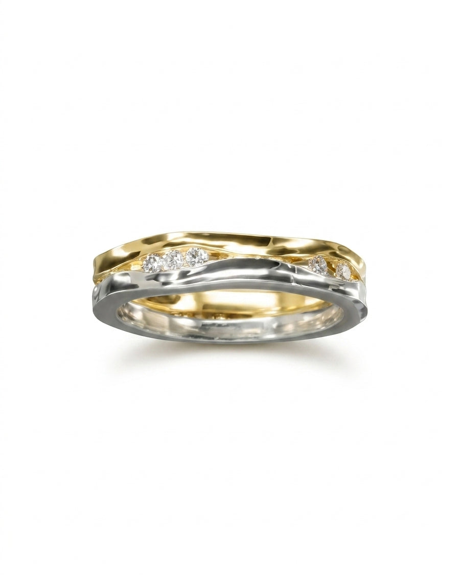 Two-colour gold and silver trap diamond ring with wavy bands.