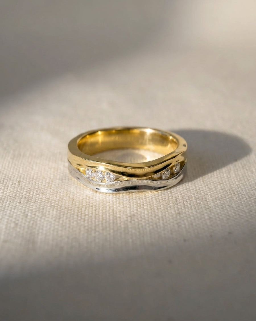 9ct white and yellow gold two-colour diamond ring with a wavy design.