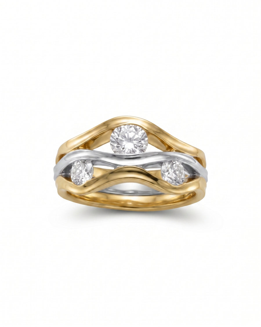 Two-colour gold ring with three round diamonds in a wavy design.