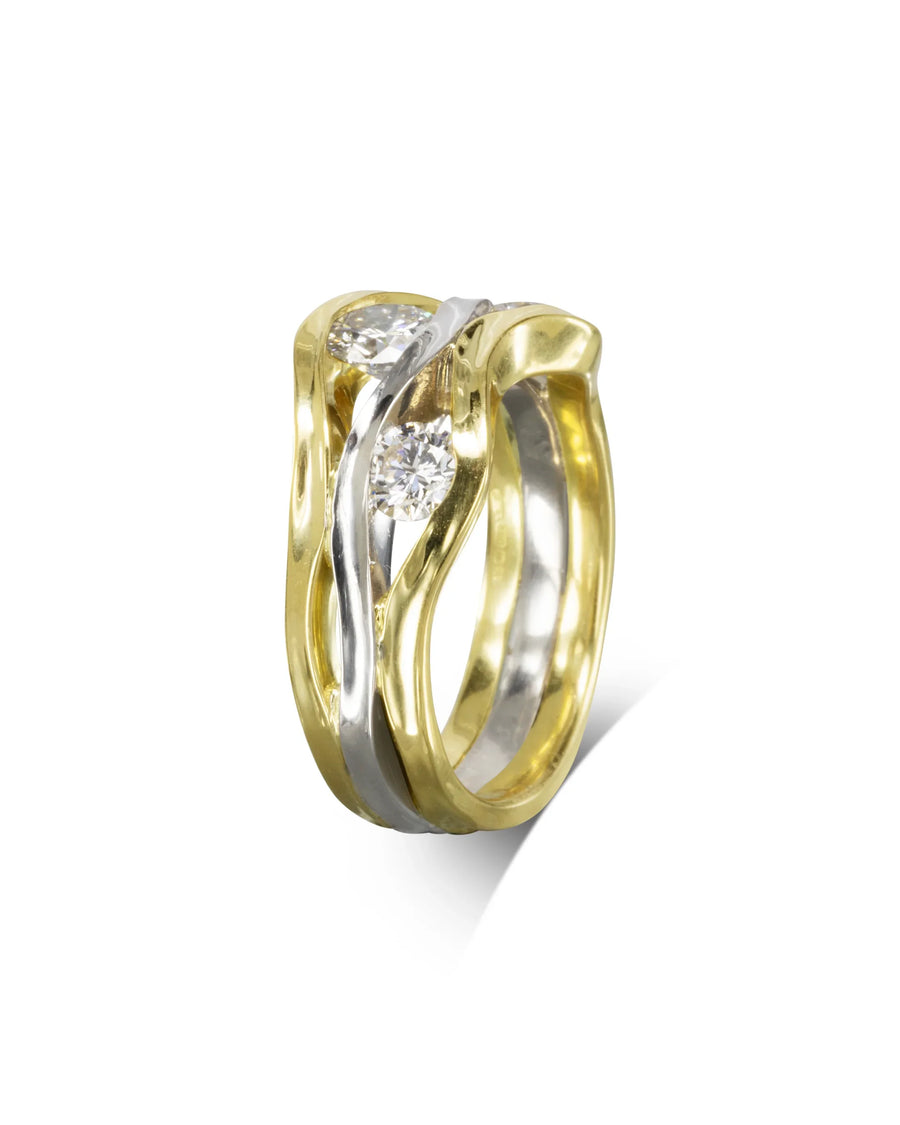 Two-colour gold ring with three round diamonds in a trap design.
