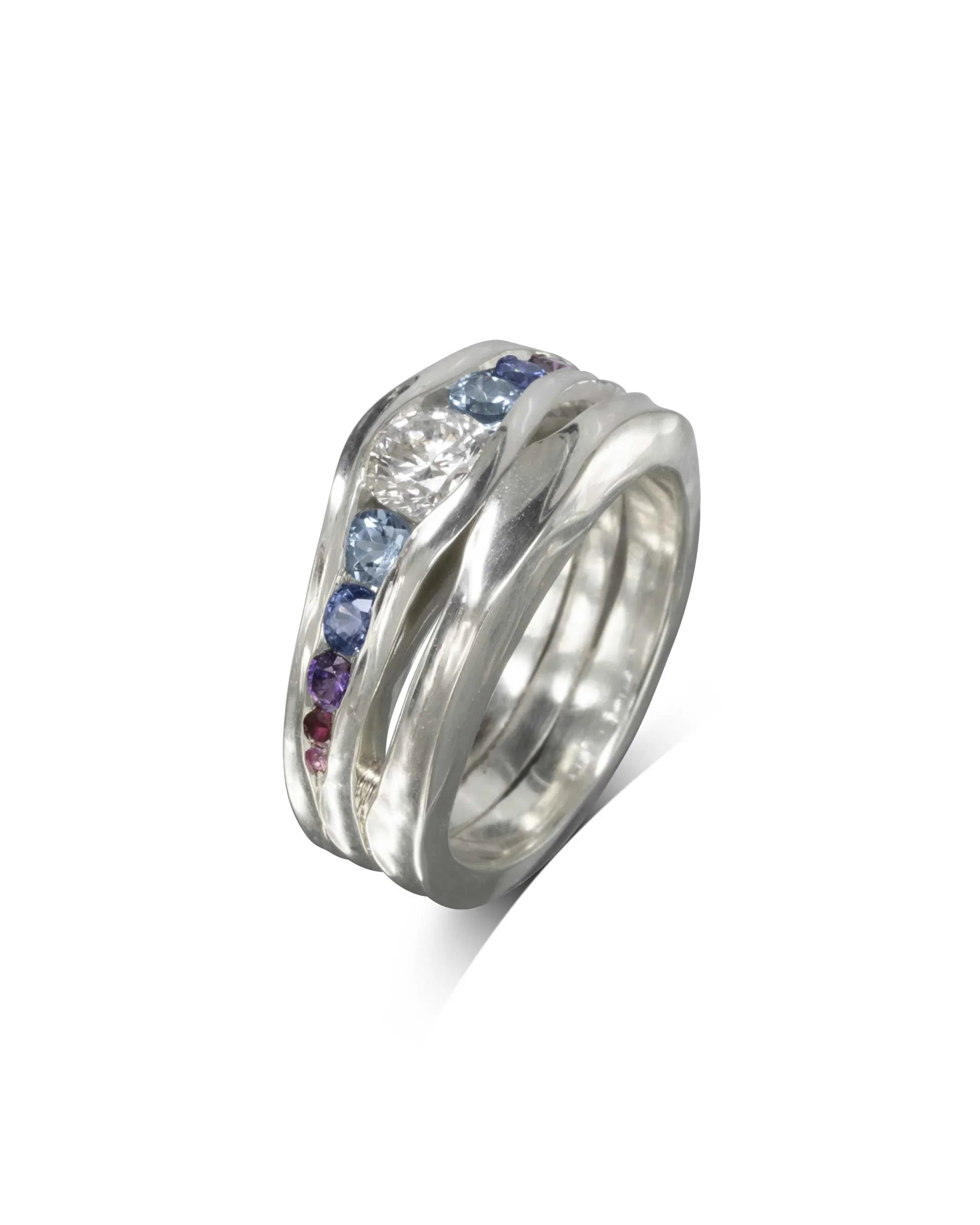 Handmade white gold engagement ring with graduated blue sapphires and textured organic band